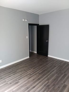 Indianapolis apartment for rent - A room with a black door and a grey wall.