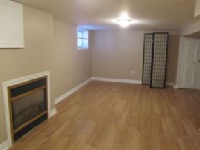 Hamilton apartment for rent - a living room with a fireplace and a wooden floor