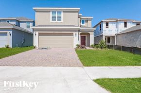 Kissimmee house for rent - a house with a driveway and a garage door