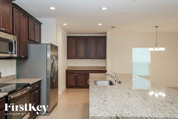 Kissimmee house for rent - a kitchen with granite counter tops and stainless steel appliances