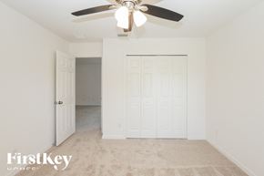 Kissimmee house for rent - a bedroom with a ceiling fan and a closet
