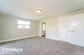 Rotonda West house for rent - a bedroom with carpet and a door to a bathroom