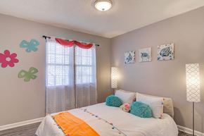 Greensboro apartment for rent - a bedroom with a bed and some paintings on the wall