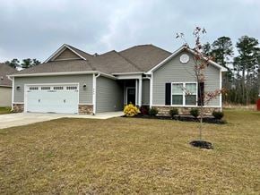 Jacksonville house for rent - A house with a grey roof and a white garage door.