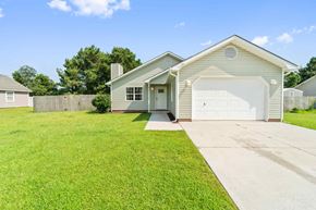 Hubert house for rent - A house with a white garage door and a brown roof.