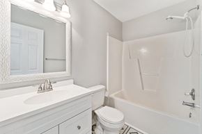 Hubert house for rent - A white bathroom with a sink, toilet, and bathtub.