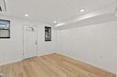 Jersey City apartment for rent - an empty living room with white walls and a wooden floor