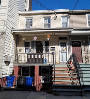 Jersey City apartment for rent - the front of a house with stairs and a porch