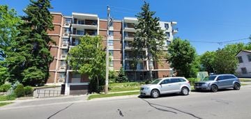Oshawa apartment for rent - two cars parked in front of an apartment building