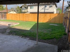 Monrovia apartment for rent - A backyard with a wooden fence and a green lawn.