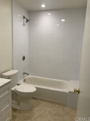 Monrovia apartment for rent - A white bathroom with a toilet, sink, and bathtub.