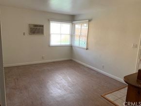 Monrovia apartment for rent - A room with a window and a wooden table.