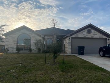 Killeen house for rent - A house with a garage and a car parked in front.