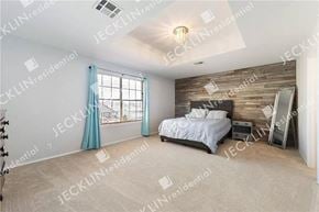 Hutto house for rent - a bedroom with a bed and a large window