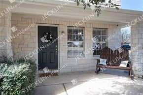 Hutto house for rent - a front porch with a bench in front of a house