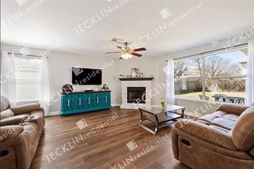 Hutto house for rent - a living room with couches and a tv and a fireplace