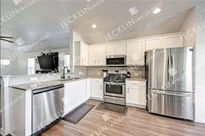 Georgetown house for rent - a large kitchen with stainless steel appliances and white cabinets