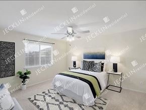 Hutto house for rent - A bedroom with a bed, two lamps, and a ceiling fan.