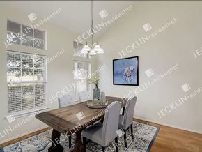 Hutto house for rent - A dining room with a wooden table and chairs.