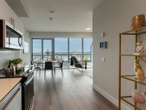 Oshawa apartment for rent - an open kitchen and living room with a view of the city
