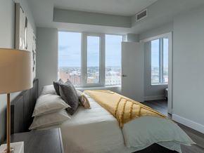 Oshawa apartment for rent - a bedroom with a bed and a view of the city
