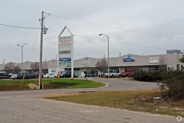 Navarre apartment for rent - a shopping mall with cars parked in front of it