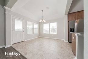 Little Elm house for rent - an empty kitchen and living room with a stainless steel refrigerator