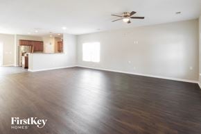 Johns Island house for rent - A spacious room with wooden flooring and a ceiling fan.