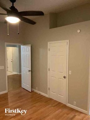 Colorado Springs house for rent - a living room with a ceiling fan and a white door