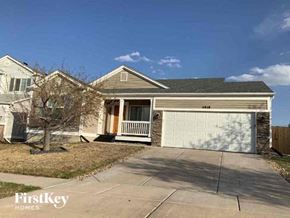 Colorado Springs house for rent - a brick house with a white garage door