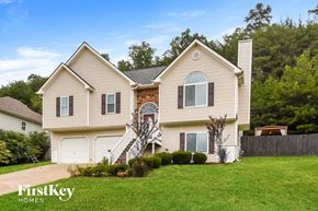 Summerville house for rent - A two-story house with a brick fireplace and a garage.