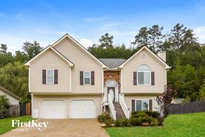 Summerville house for rent - A two-story house with a garage and a driveway in front.