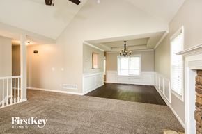 Summerville house for rent - A spacious room with a chandelier and a fireplace.
