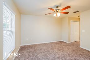 Lehigh Acres house for rent - a bedroom with a ceiling fan and a window