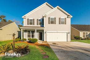 Ladson house for rent - a beige house with a white garage door