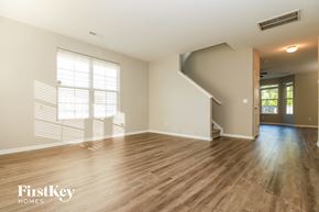 Ladson house for rent - an empty living room with hardwood floors and a staircase