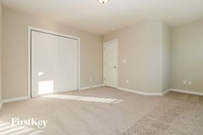 Ladson house for rent - a bedroom with two doors and a carpeted floor
