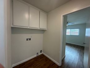 Whittier apartment for rent - A room with white cabinets and wood floors.