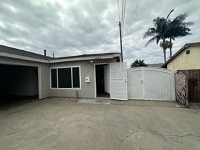 Whittier apartment for rent - A house with a garage and a fence.