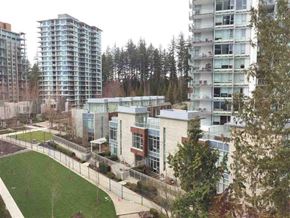 Vancouver apartment for rent - A modern building with a green lawn in front.