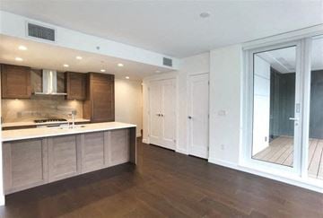 Vancouver apartment for rent - A kitchen with wooden cabinets and a white countertop.