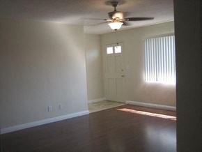 Covina apartment for rent - A room with a ceiling fan and a door.