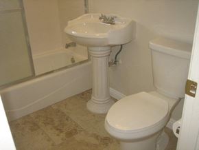 Covina apartment for rent - A white toilet with a pedestal sink in a bathroom.