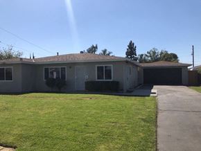 Covina apartment for rent - A house with a grey roof and a green lawn.