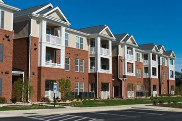 Fall River apartment for rent - a row of brick and white apartment buildings on a street