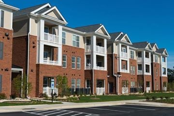 Fall River apartment for rent - a row of brick and white apartment buildings on a street