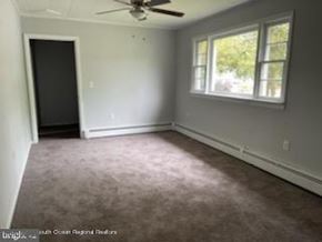 Ocean Township house for rent - A room with a ceiling fan and a window.