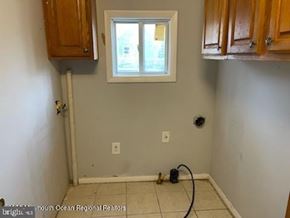 Ocean Township house for rent - A room with a window and a pipe on the floor.