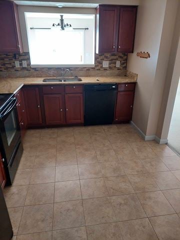 Mason apartment for rent - A kitchen with brown cabinets and a black dishwasher.