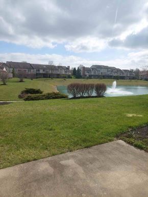 Mason apartment for rent - A pond with a fountain in the middle of a grassy area.